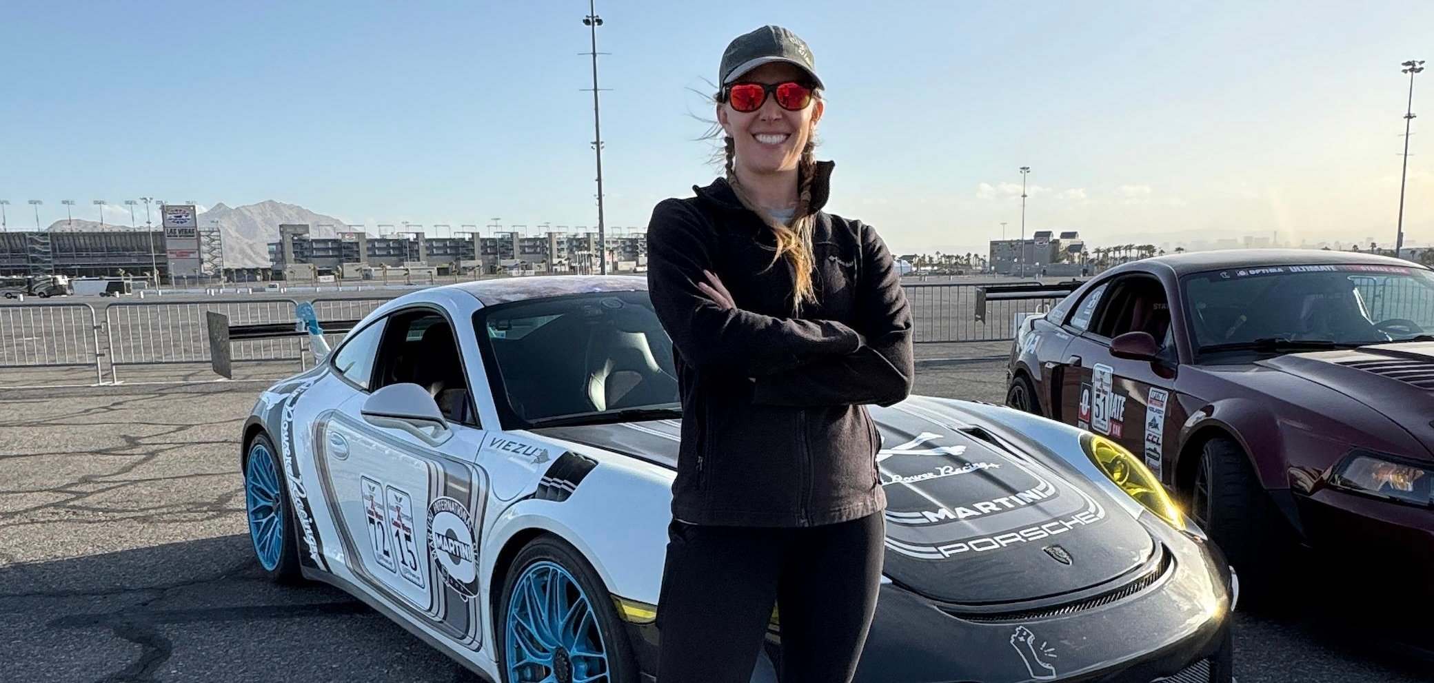a woman standing in front of a car