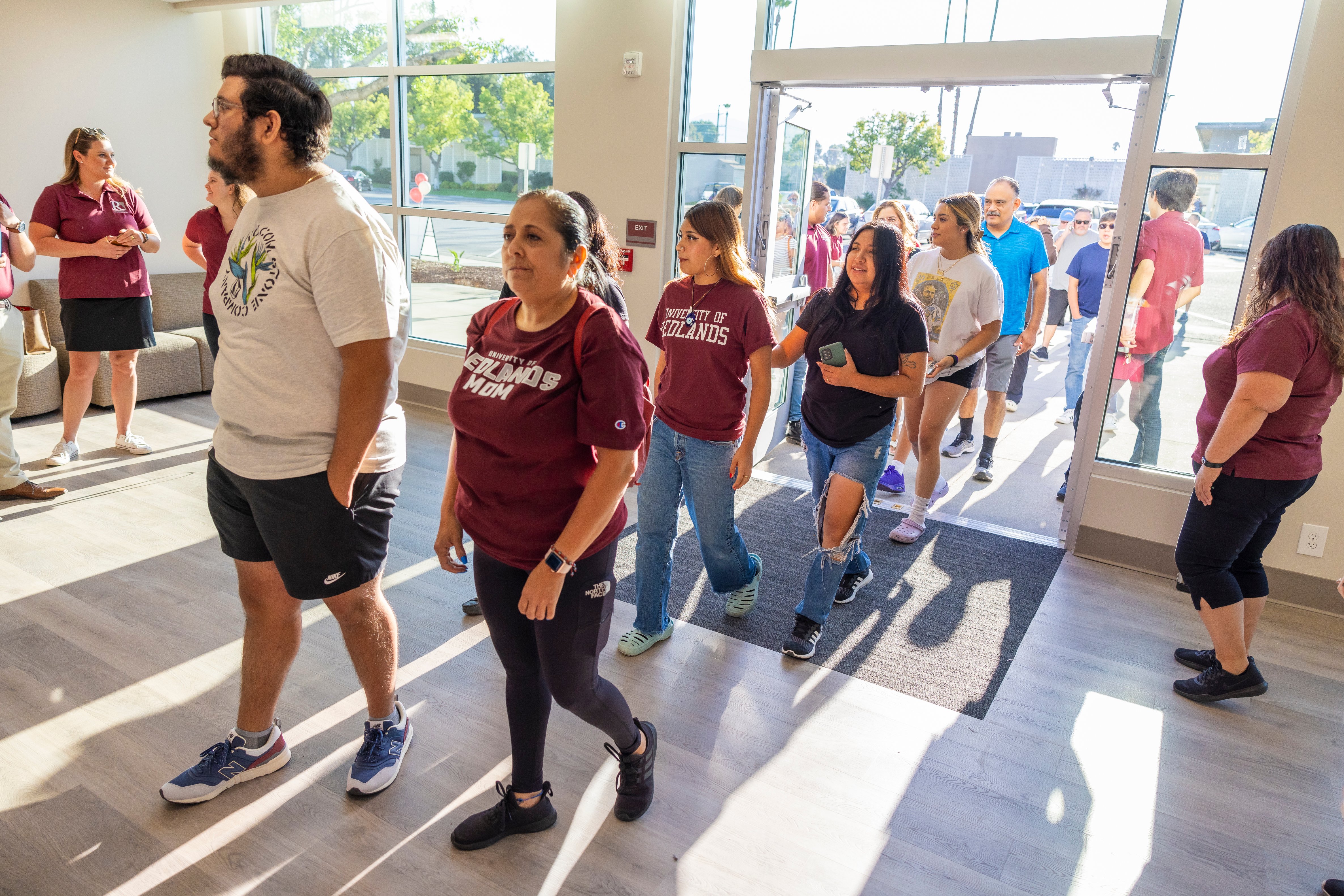 a group of people walking in a hallway