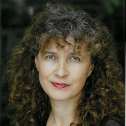 a person with curly hair and red lipstick