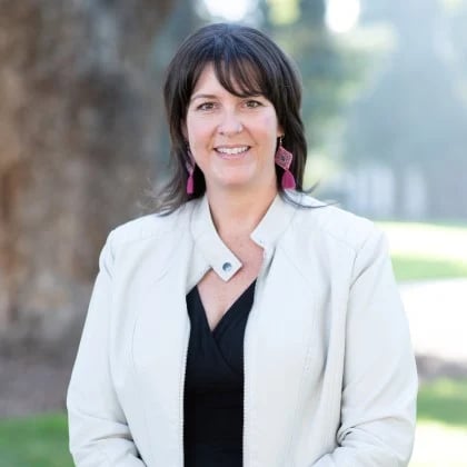 a woman in a white jacket