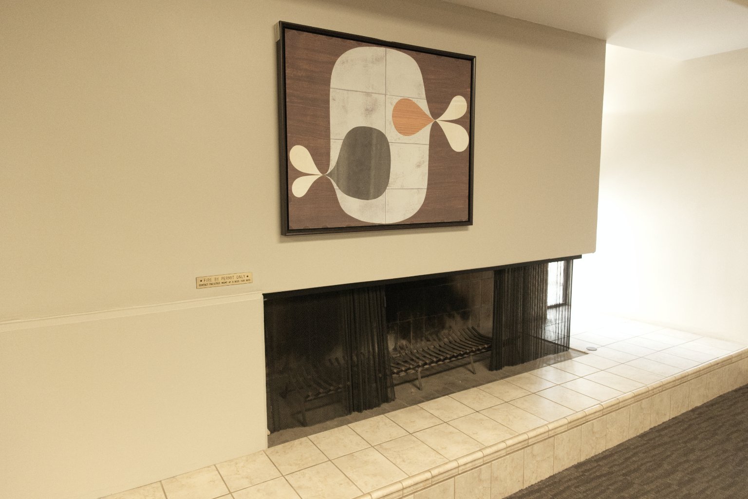 a fireplace with a painting on the wall