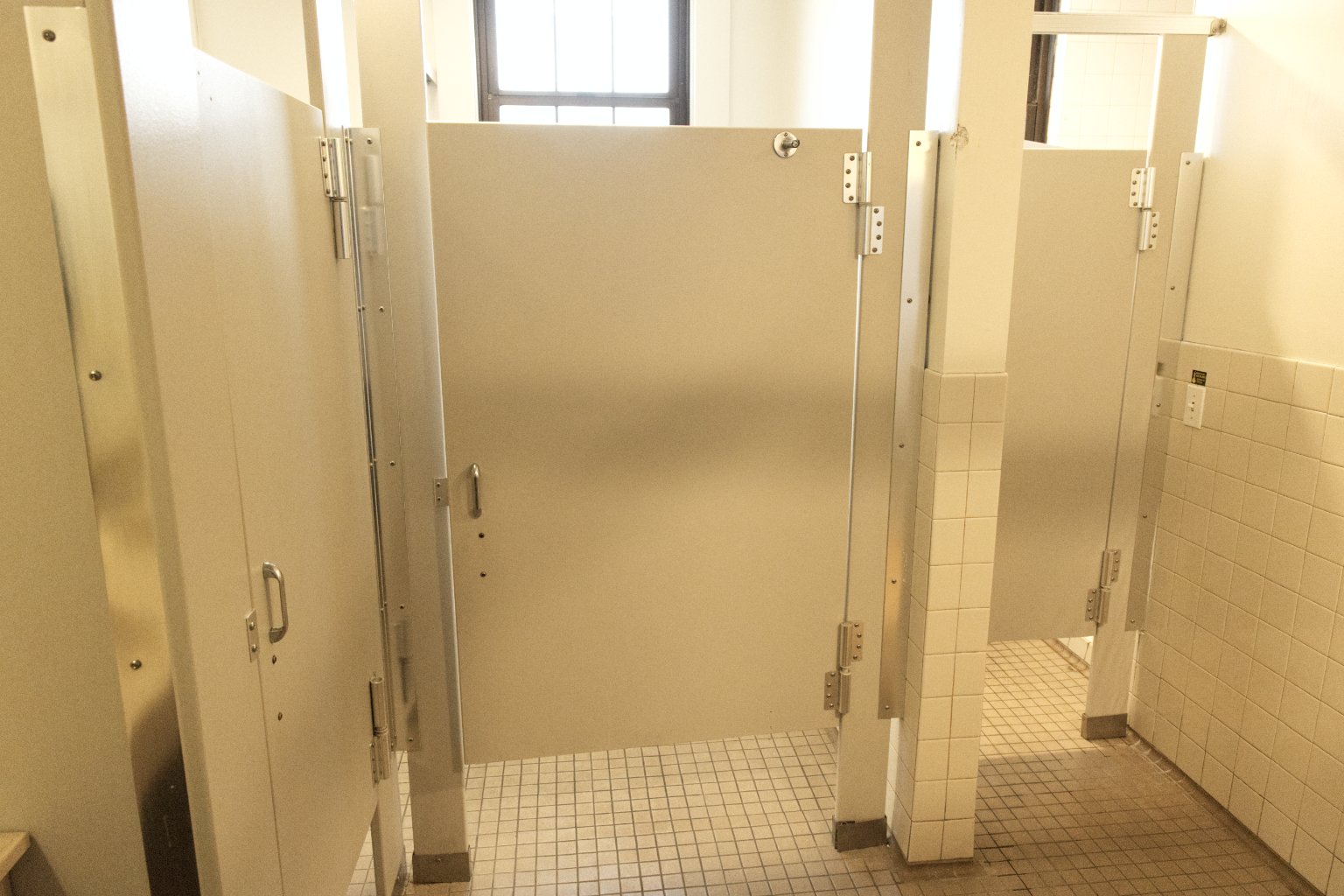 a bathroom stall with doors