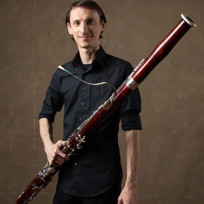 a person holding a bassoon