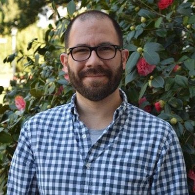 a person with a beard and glasses