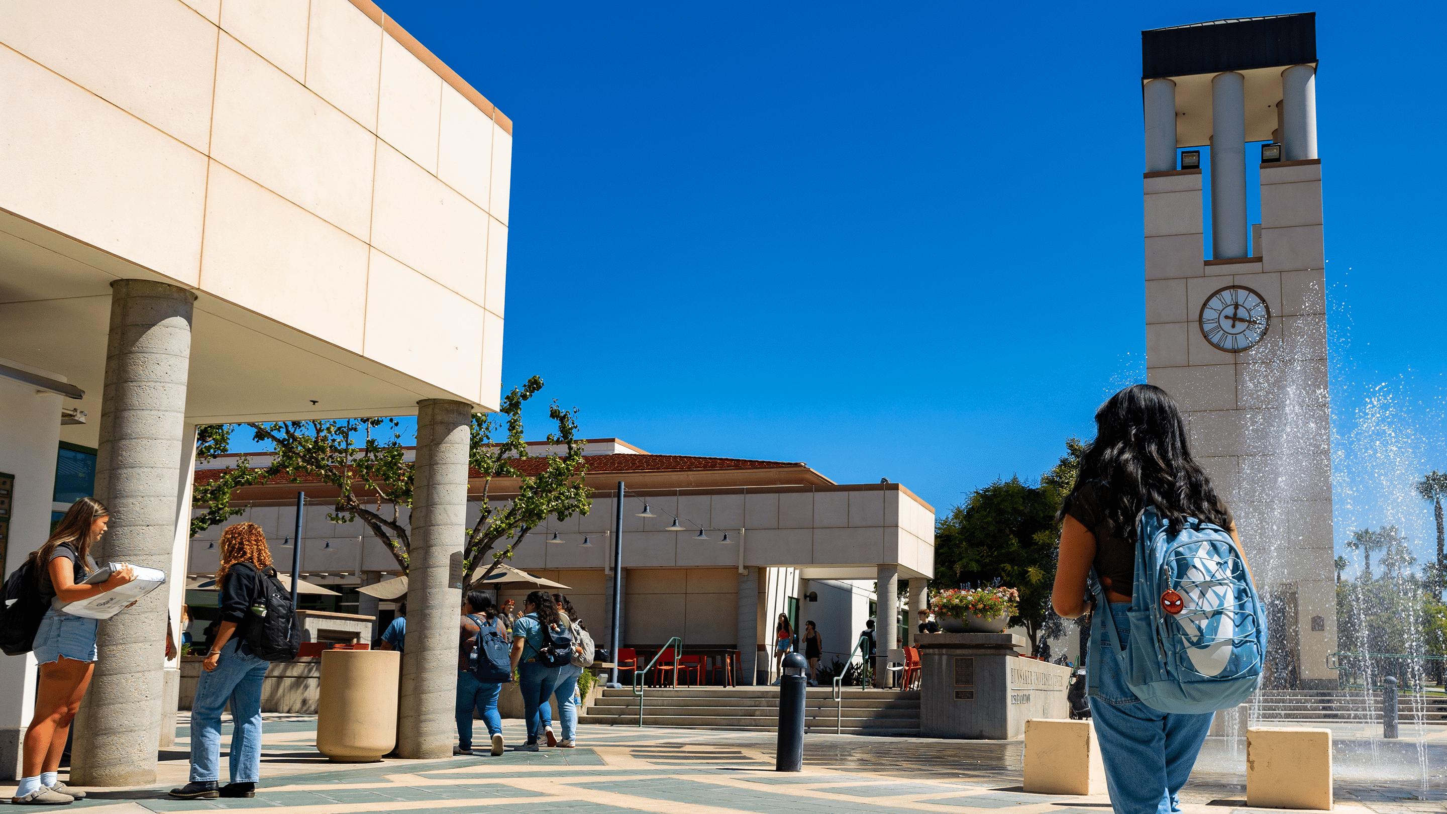 a group of people walking on a sidewalk