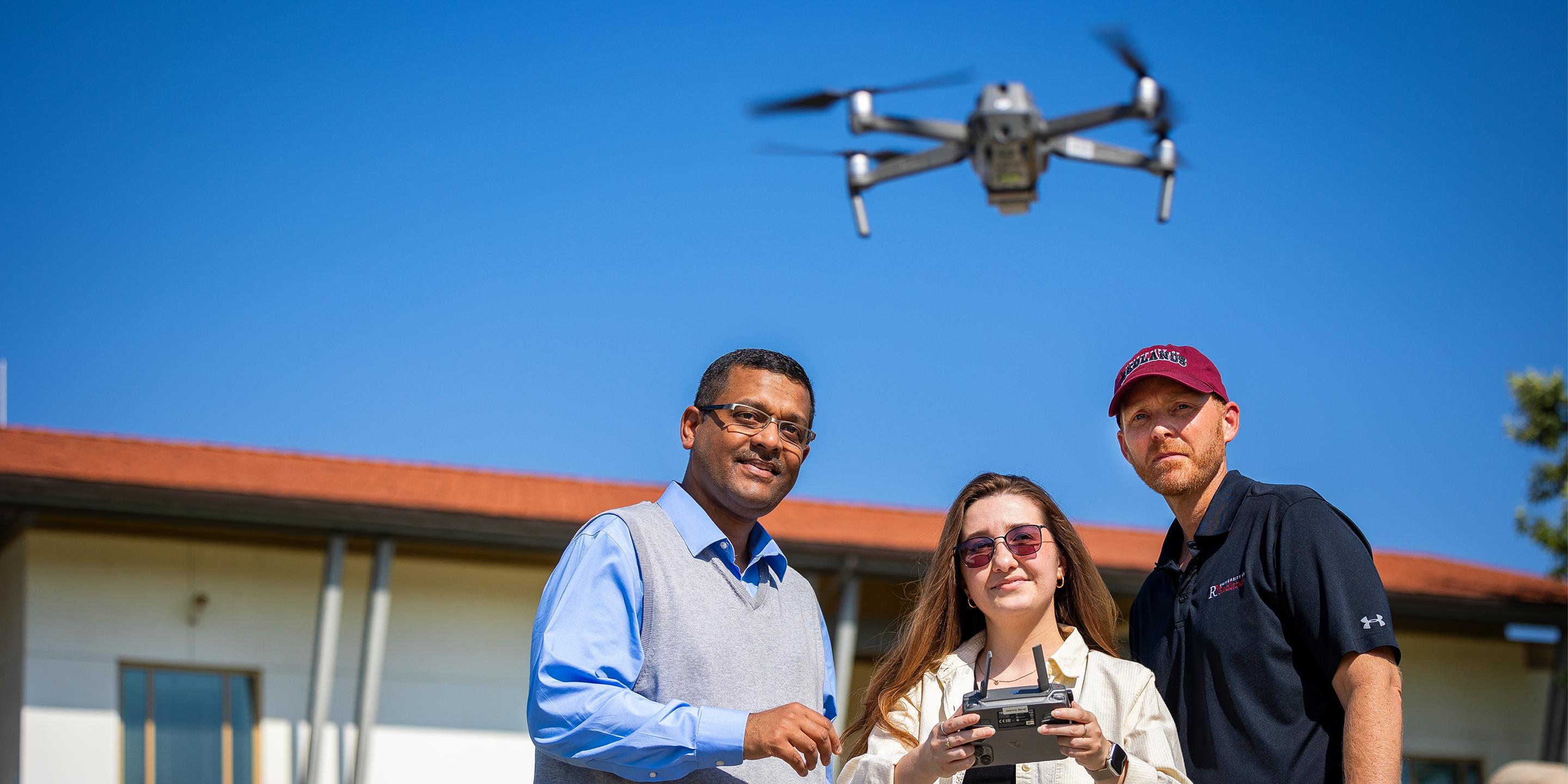 a group of people flying a drone