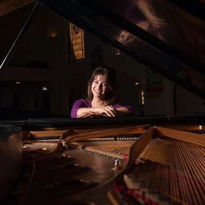 a person leaning on a piano