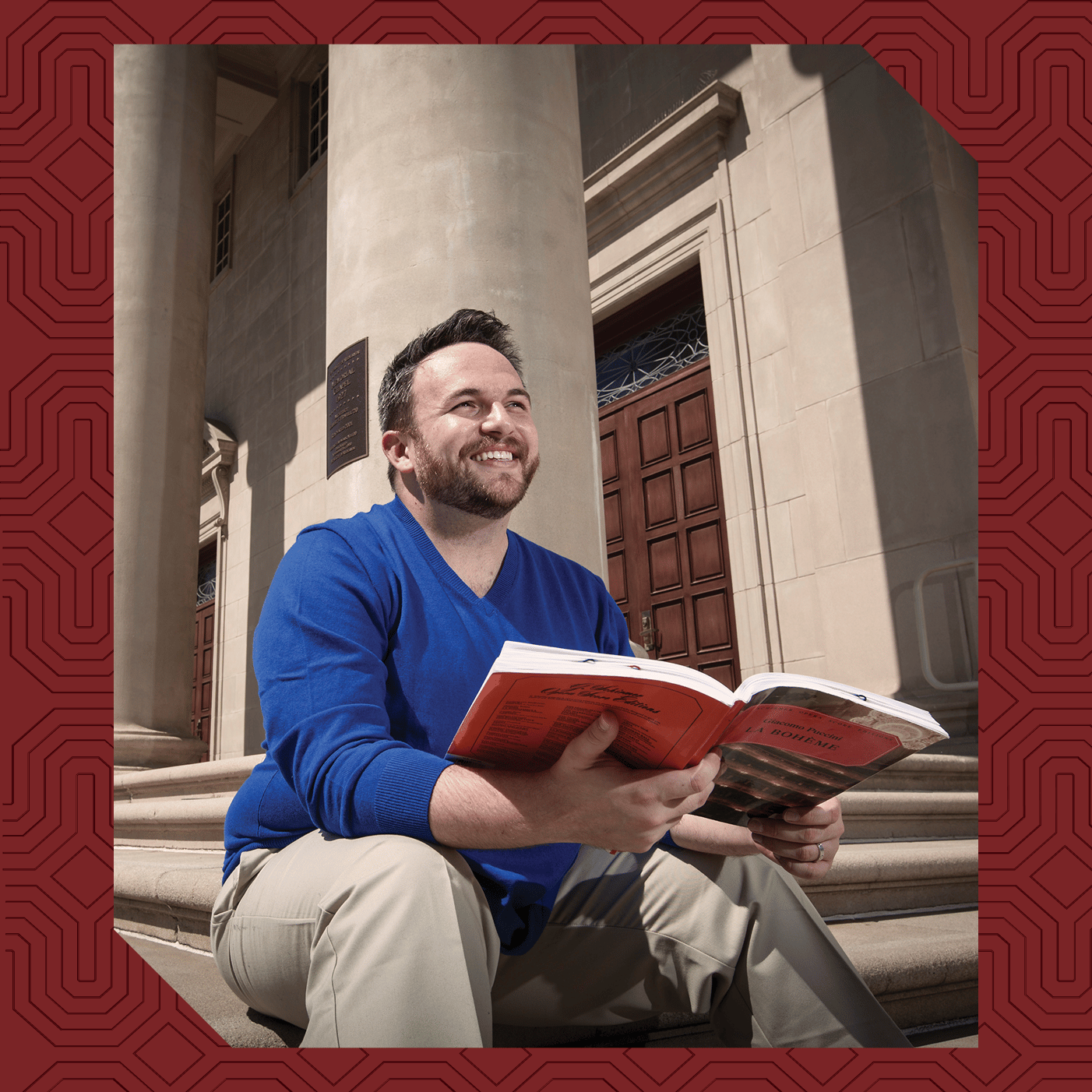 a man sitting on steps holding a book