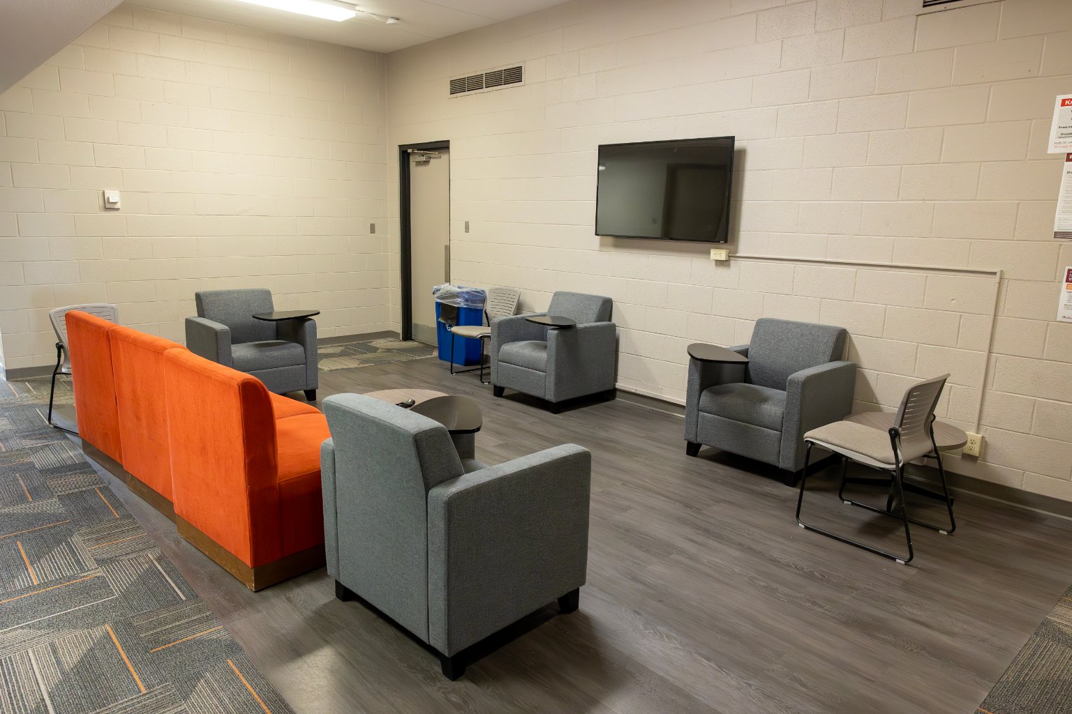 a room with chairs and a television