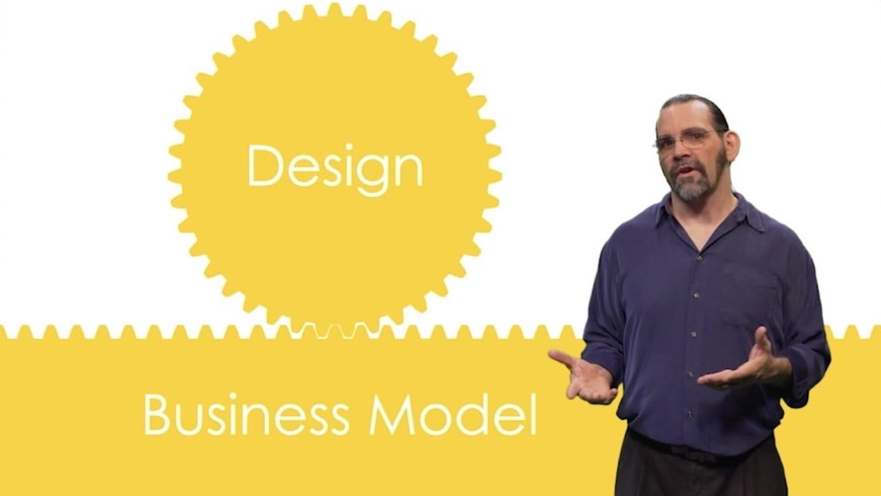 a man standing in front of a yellow sign