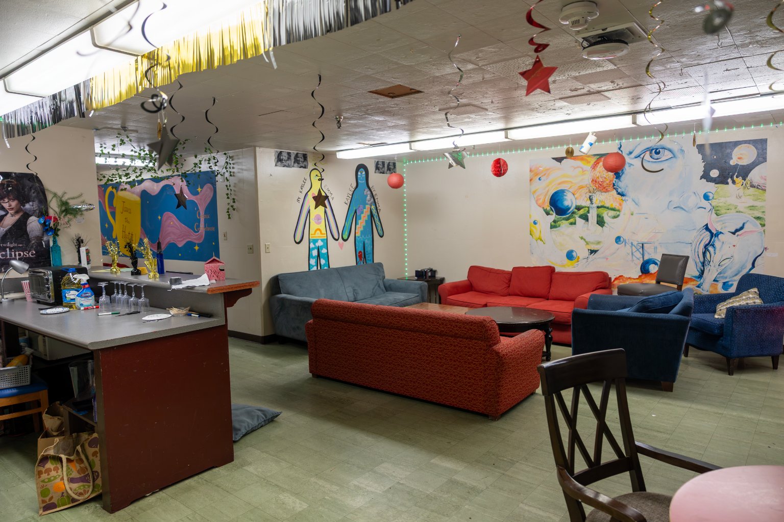 a room with couches and a bar