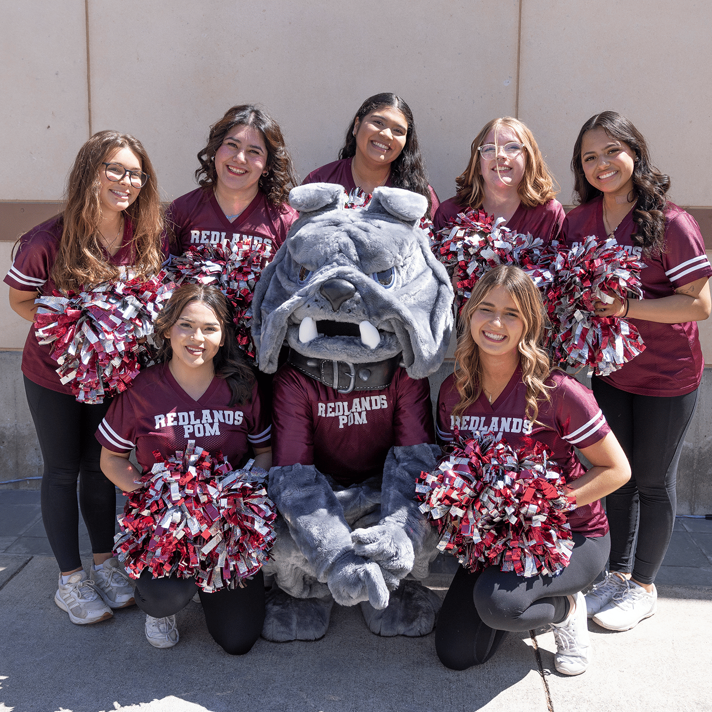 a group of women posing with pom poms