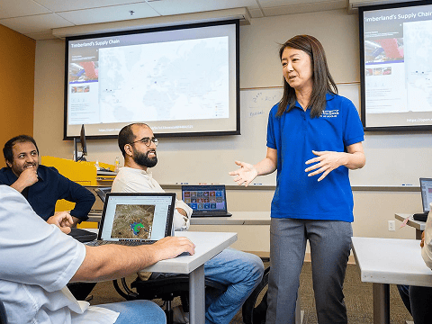 a woman standing in front of a group of people