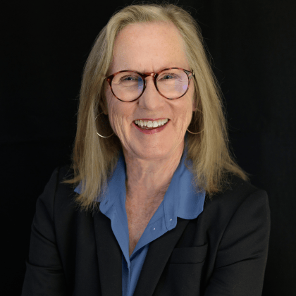 a person wearing glasses and a suit