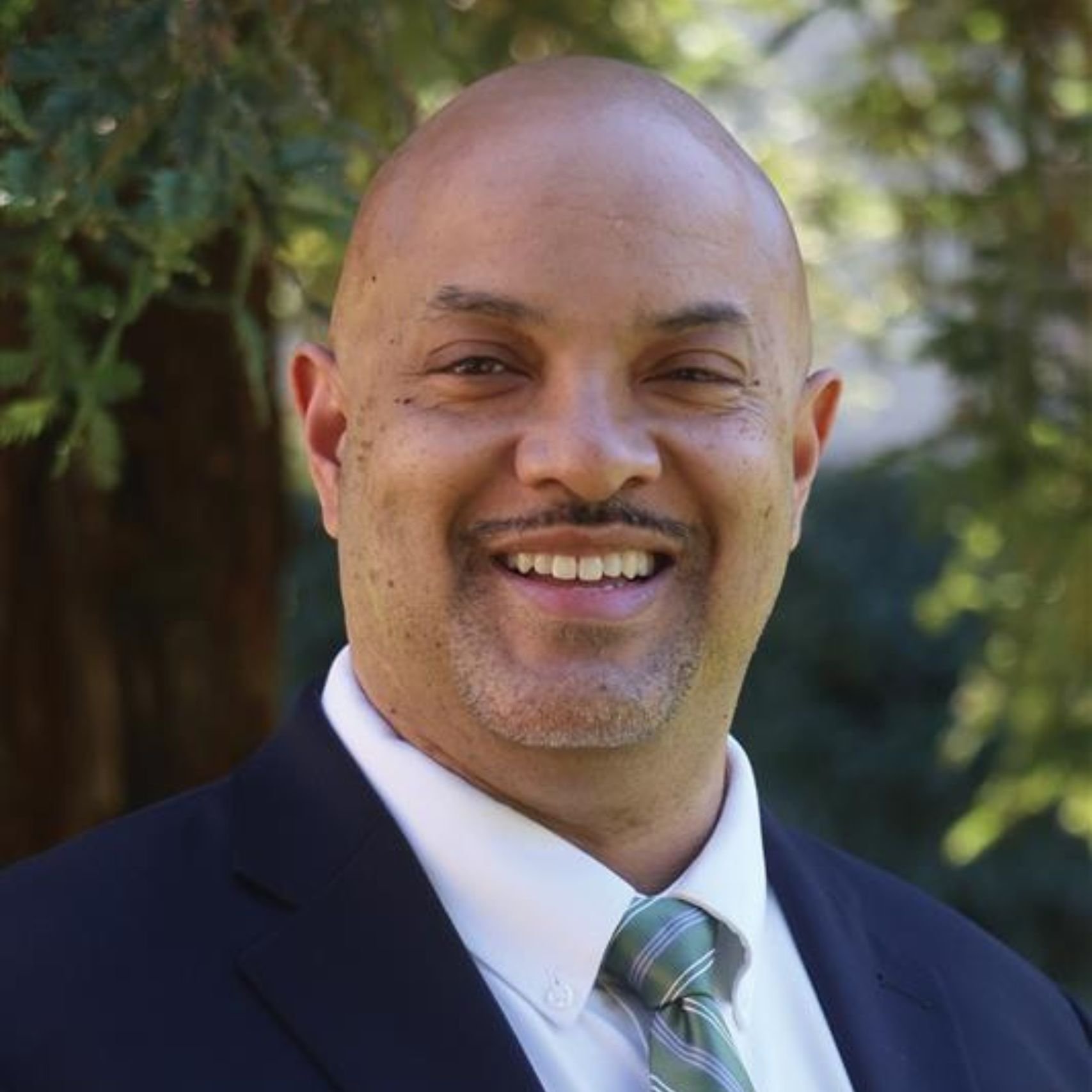 a person in a suit smiling