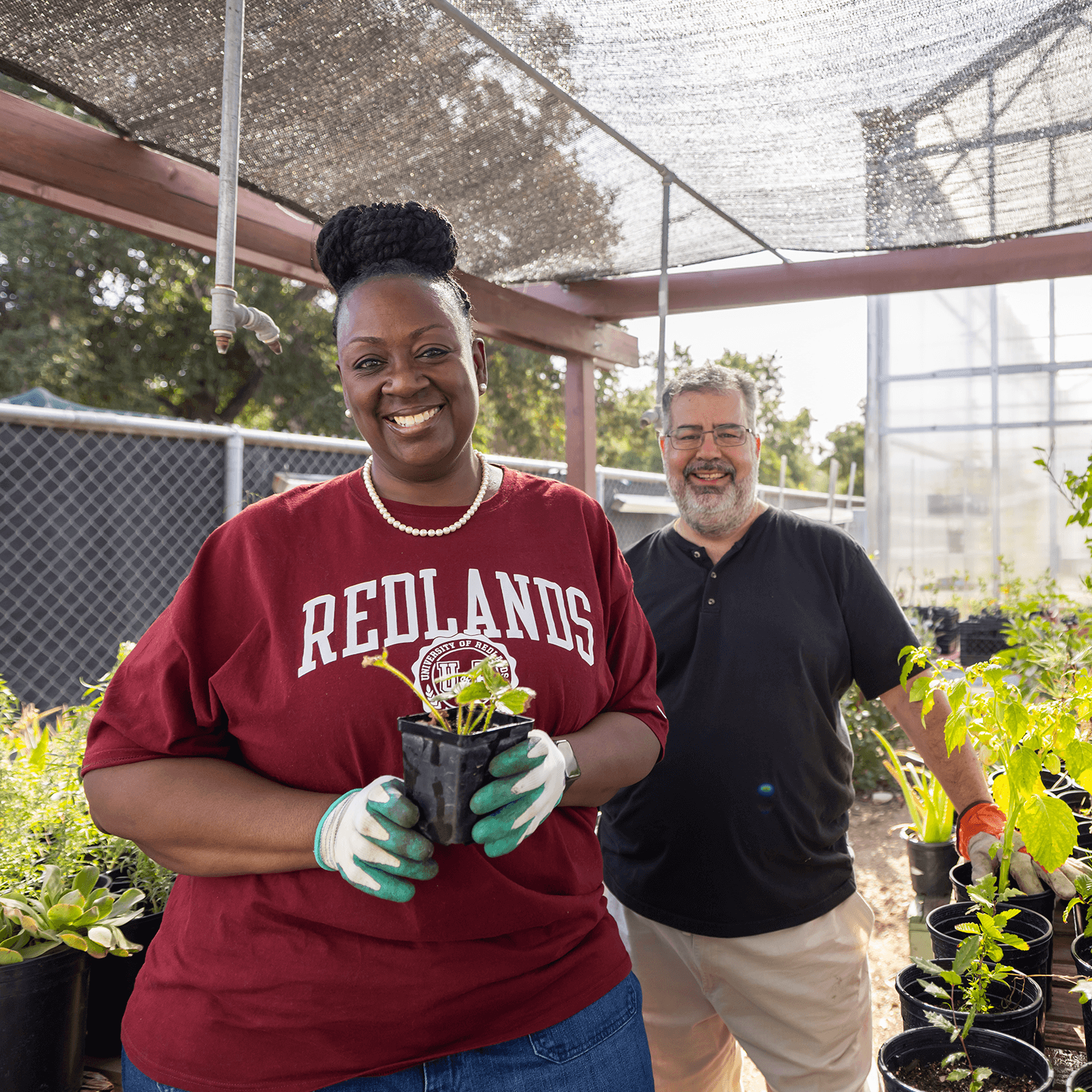 a man and woman holding a plant