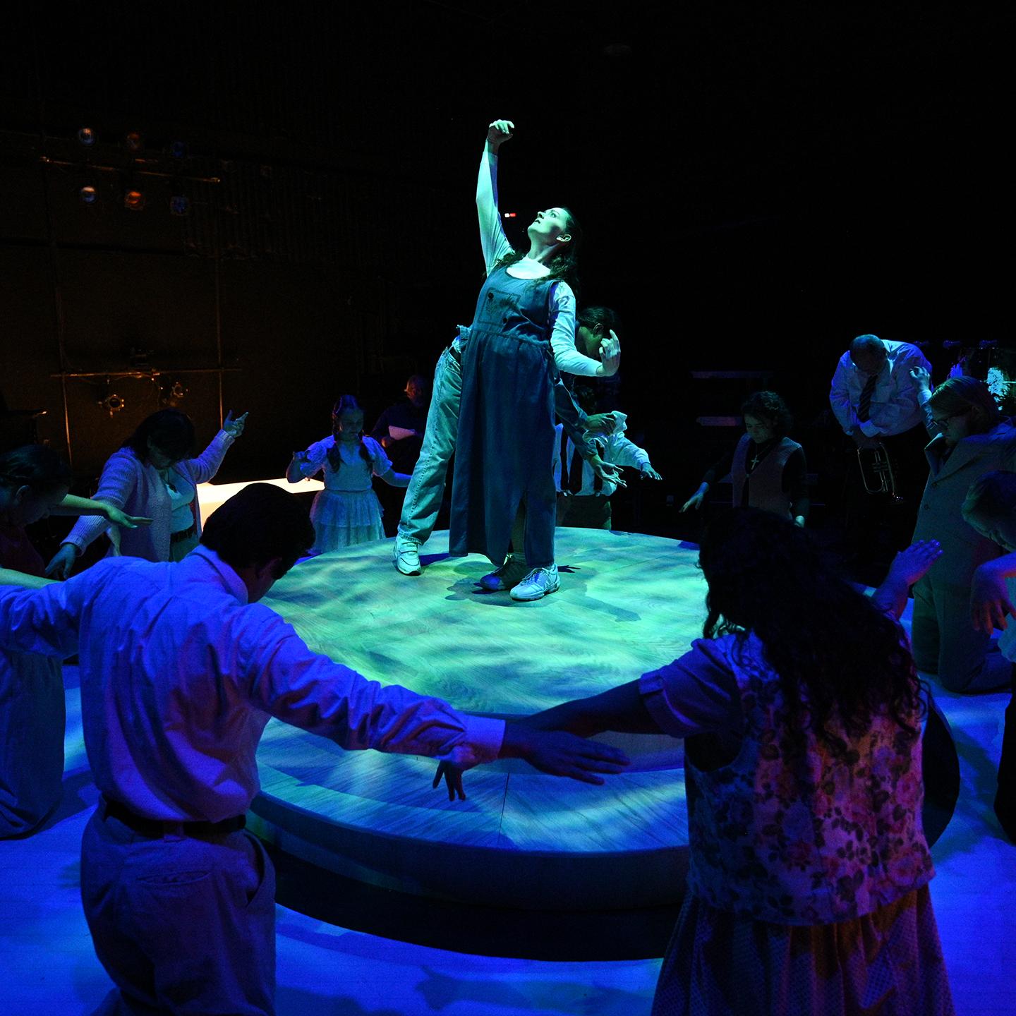 a group of people around a person on a stage