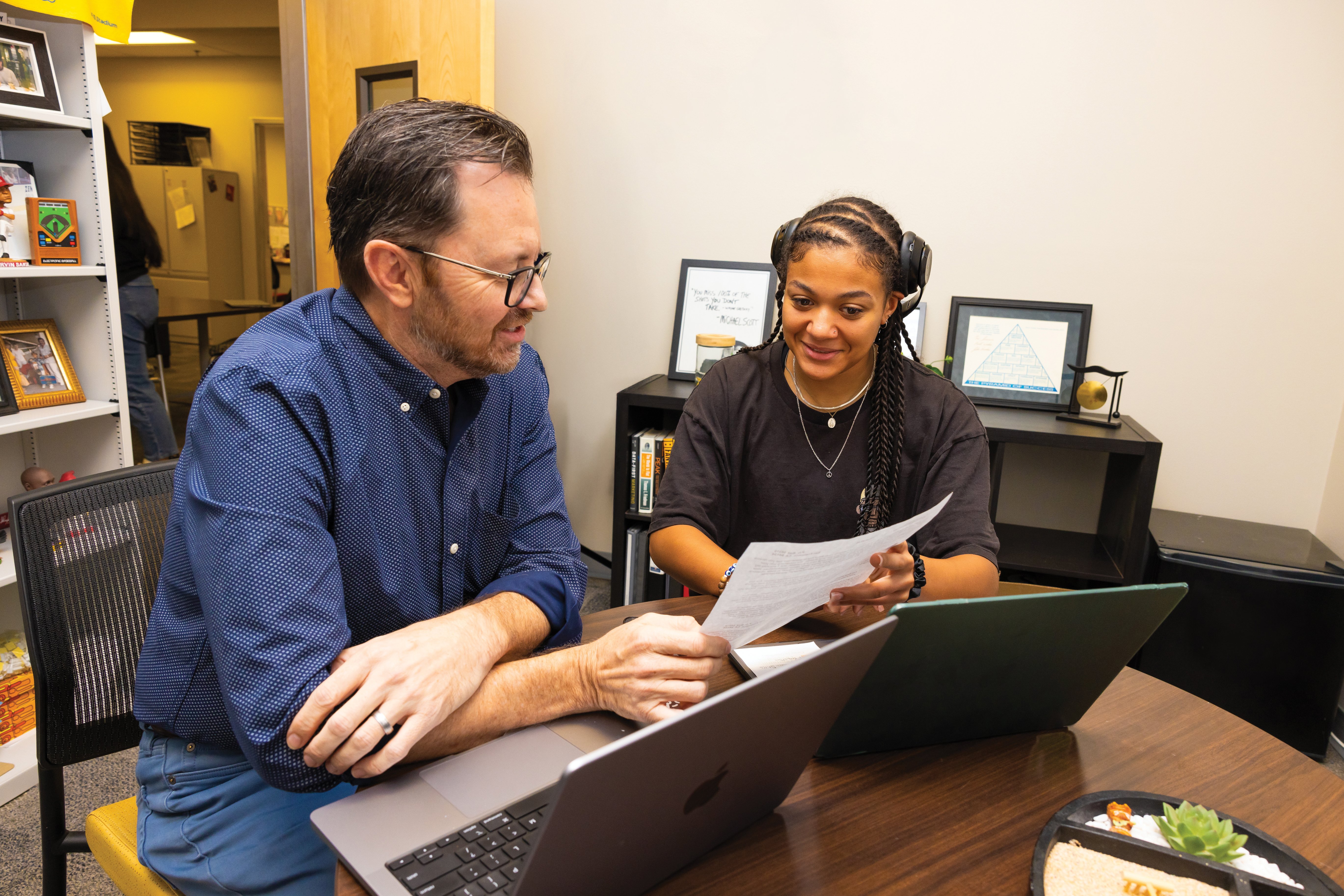 a person and person looking at papers