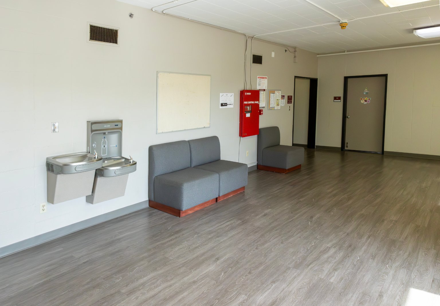a room with a grey couch and a water fountain