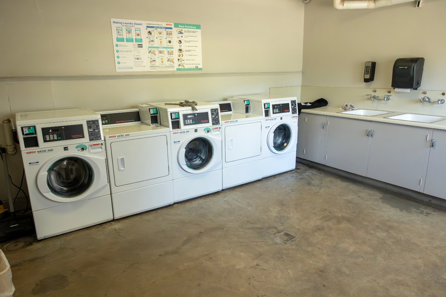 a laundry room with washers and dryers