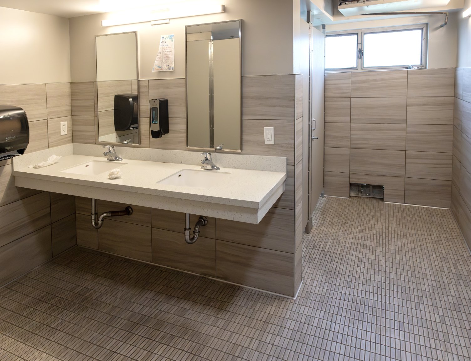 a bathroom with two sinks and mirrors