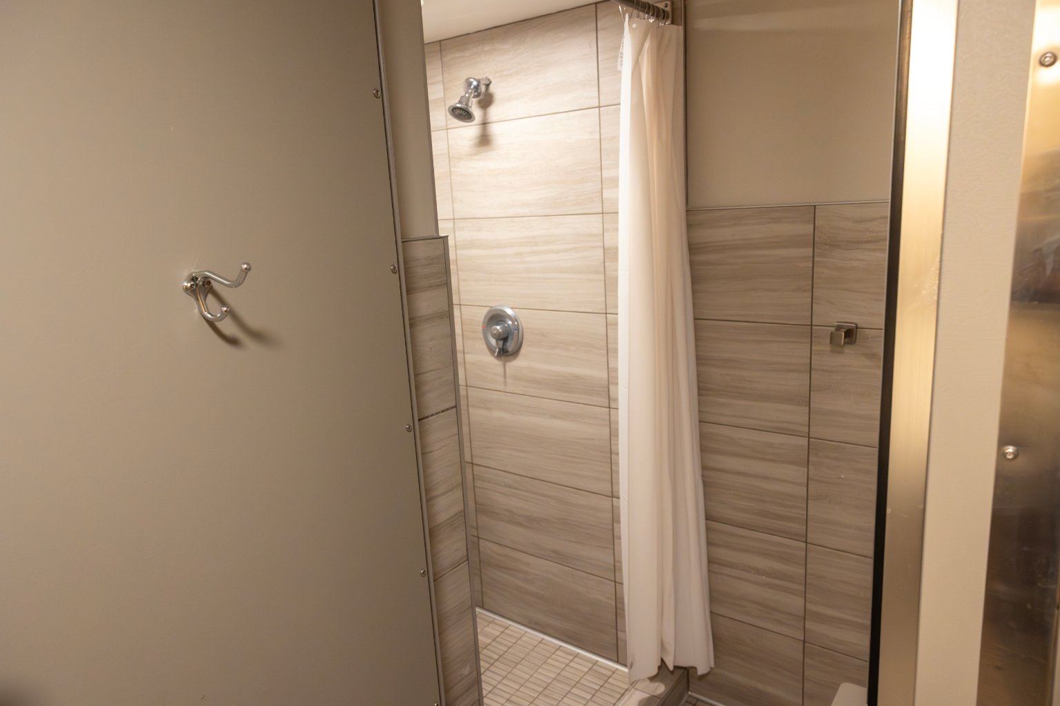 a shower with a shower head and a shower head