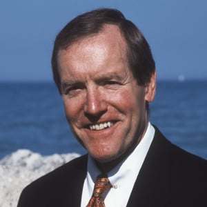 a man in a suit smiling