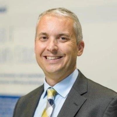 a man in a suit smiling