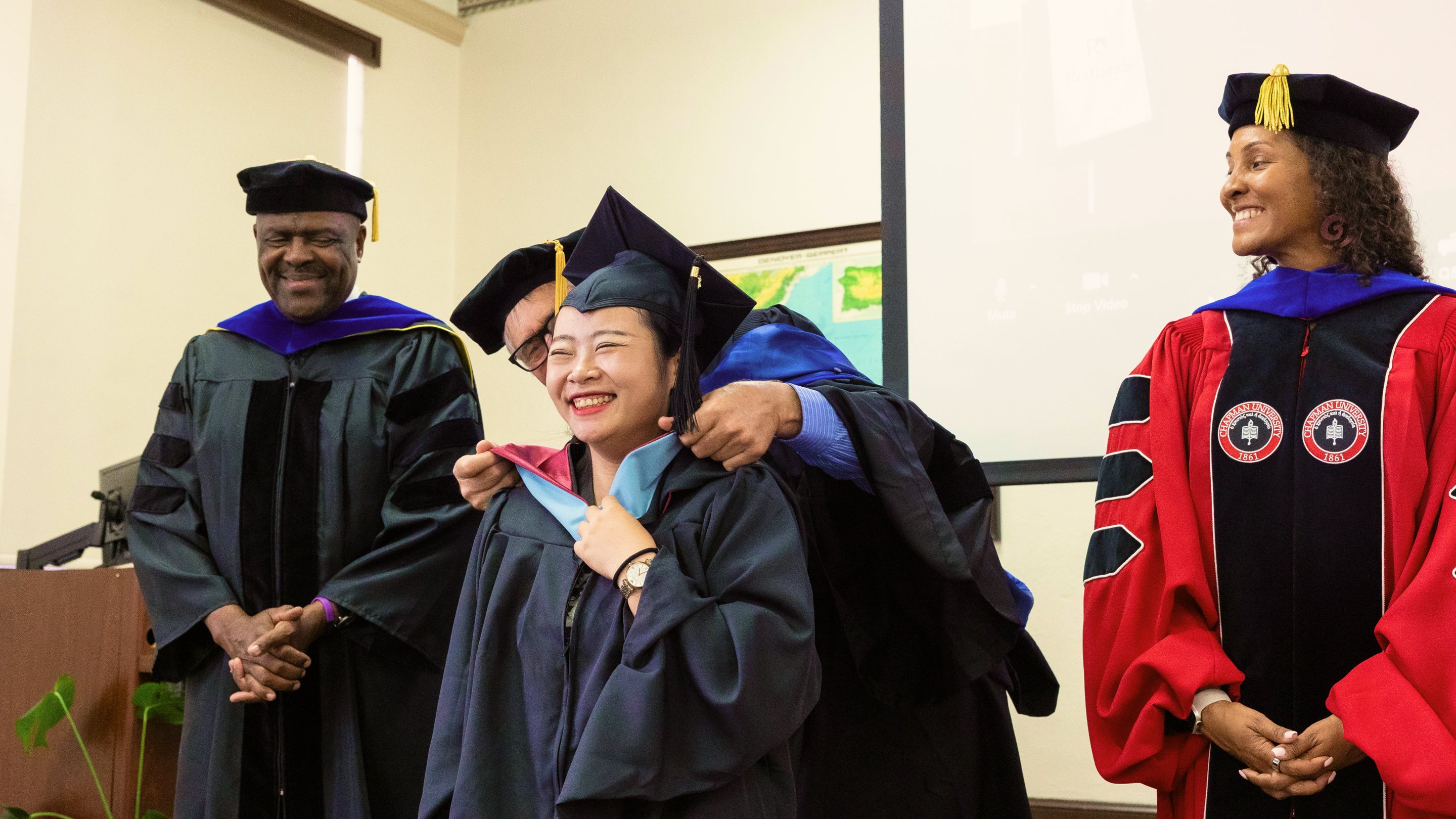 a group of people in graduation gowns and caps