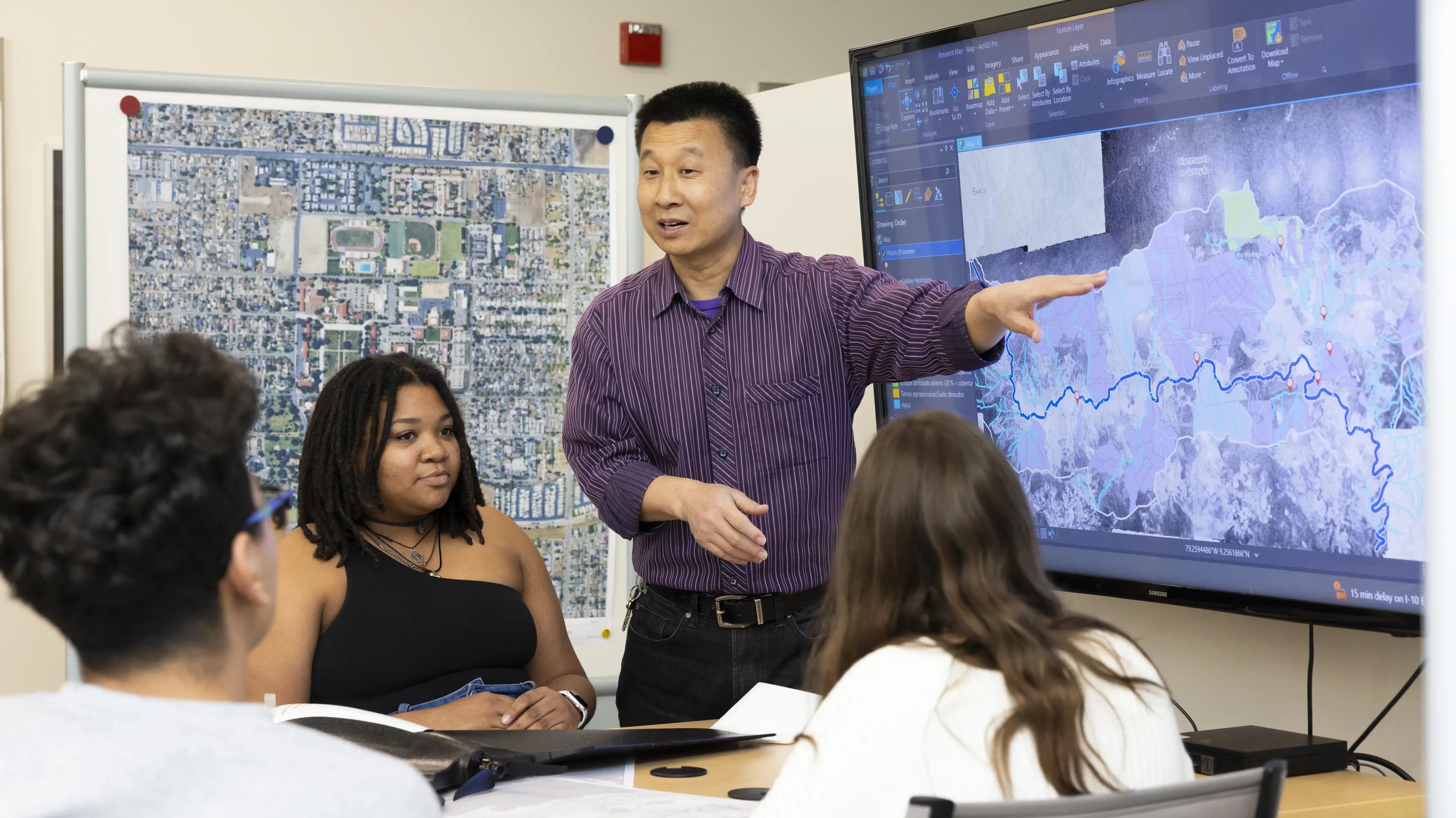 a person pointing at a screen