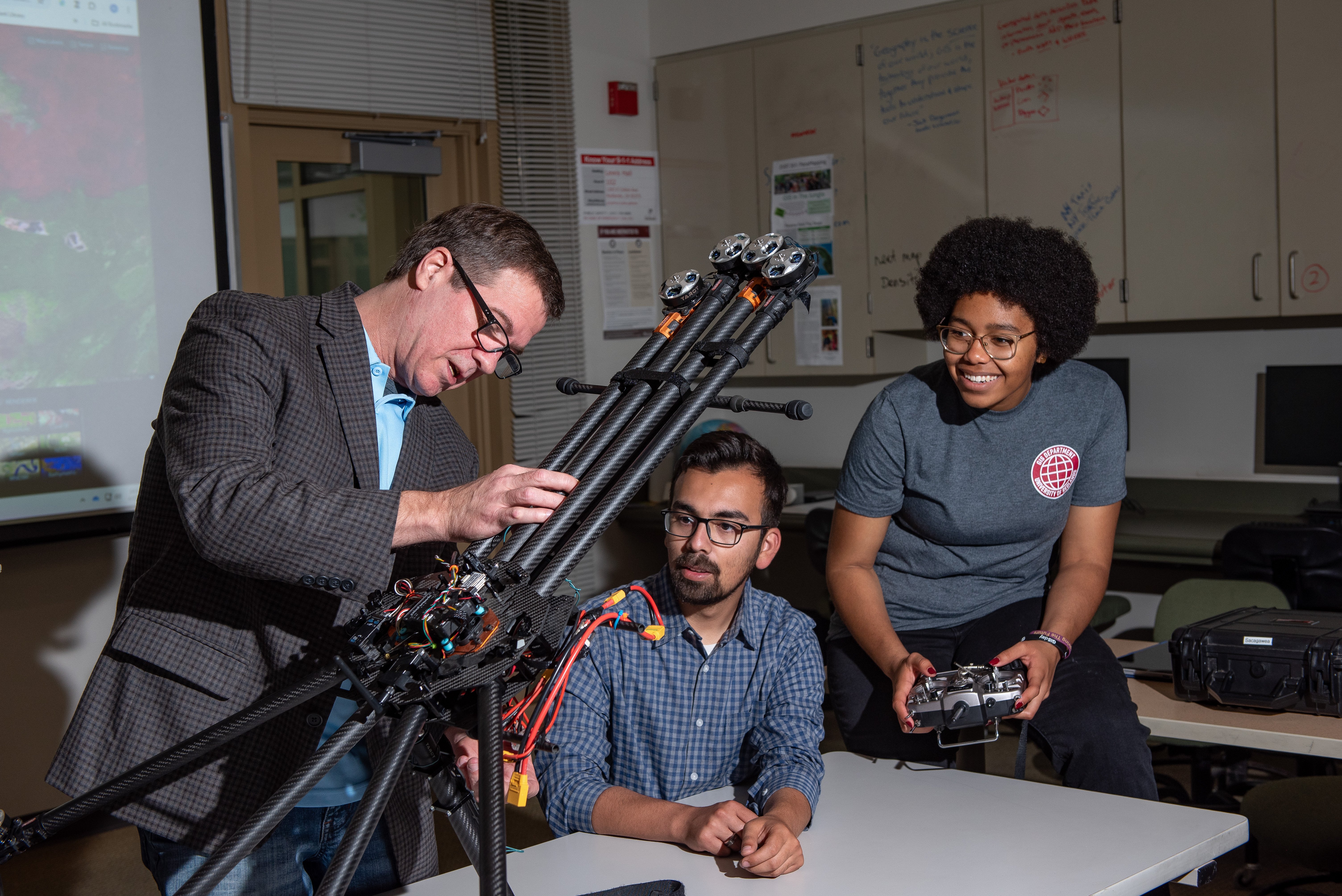 a man standing next to a man holding a machine