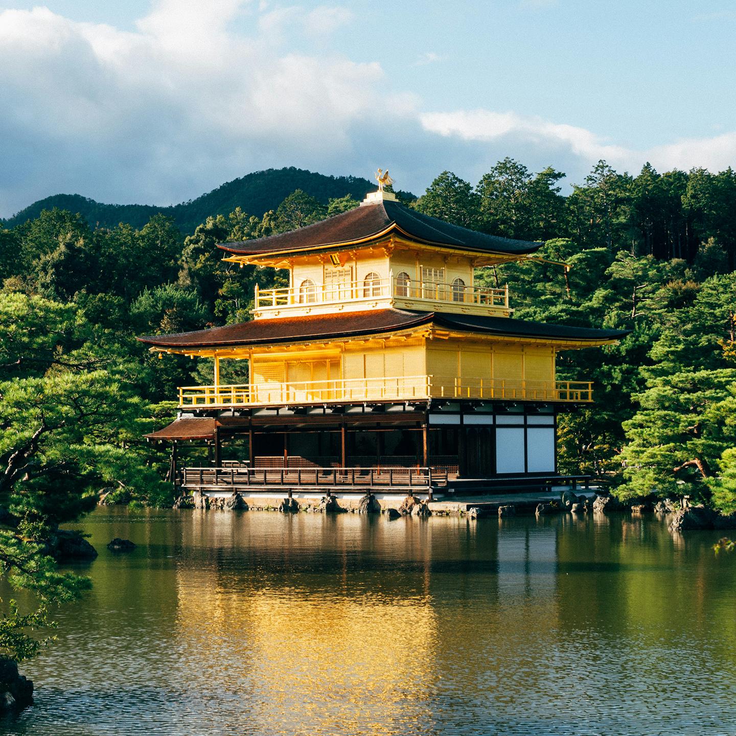 Kinkaku-ji on a lake surrounded by trees