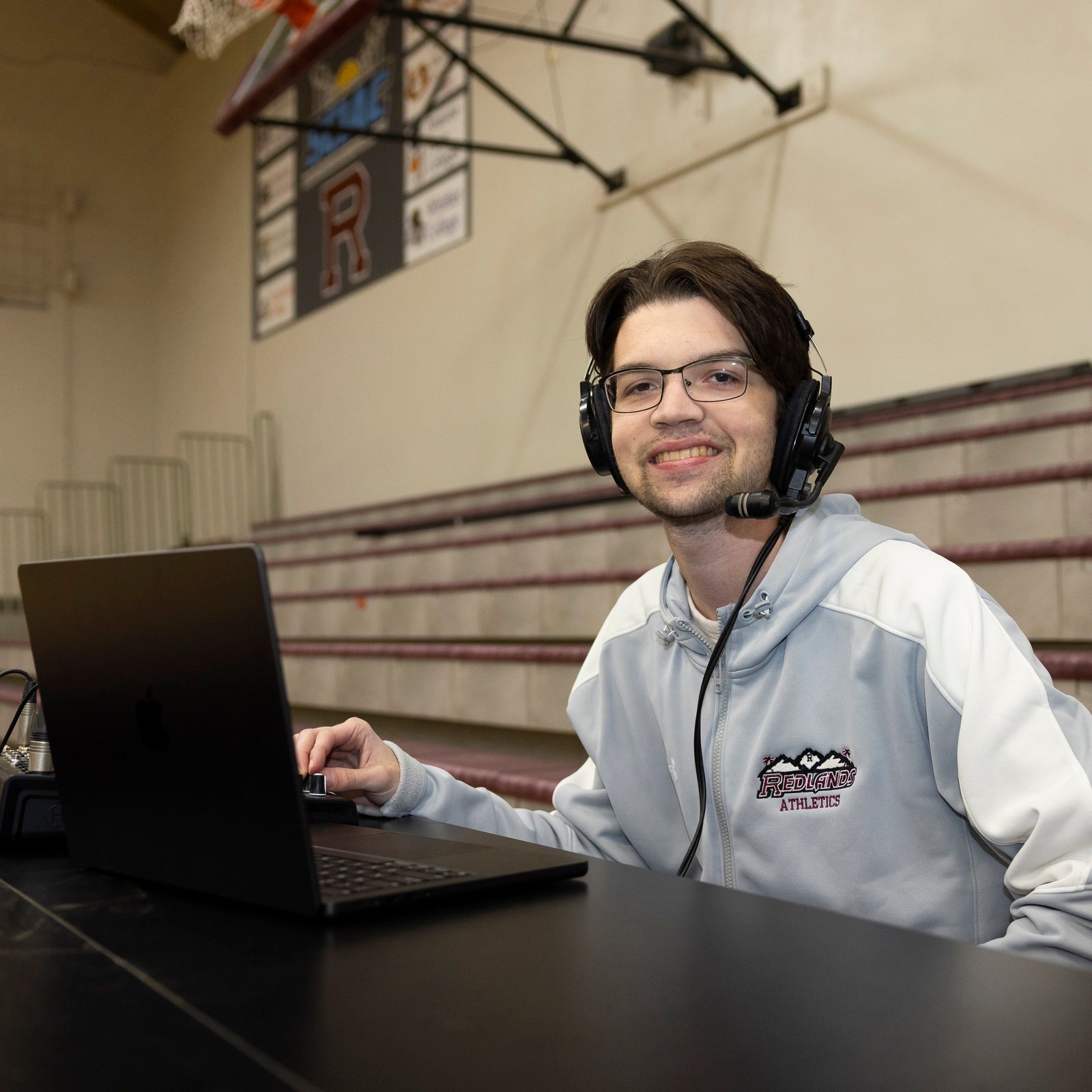 a person wearing headphones and using a laptop