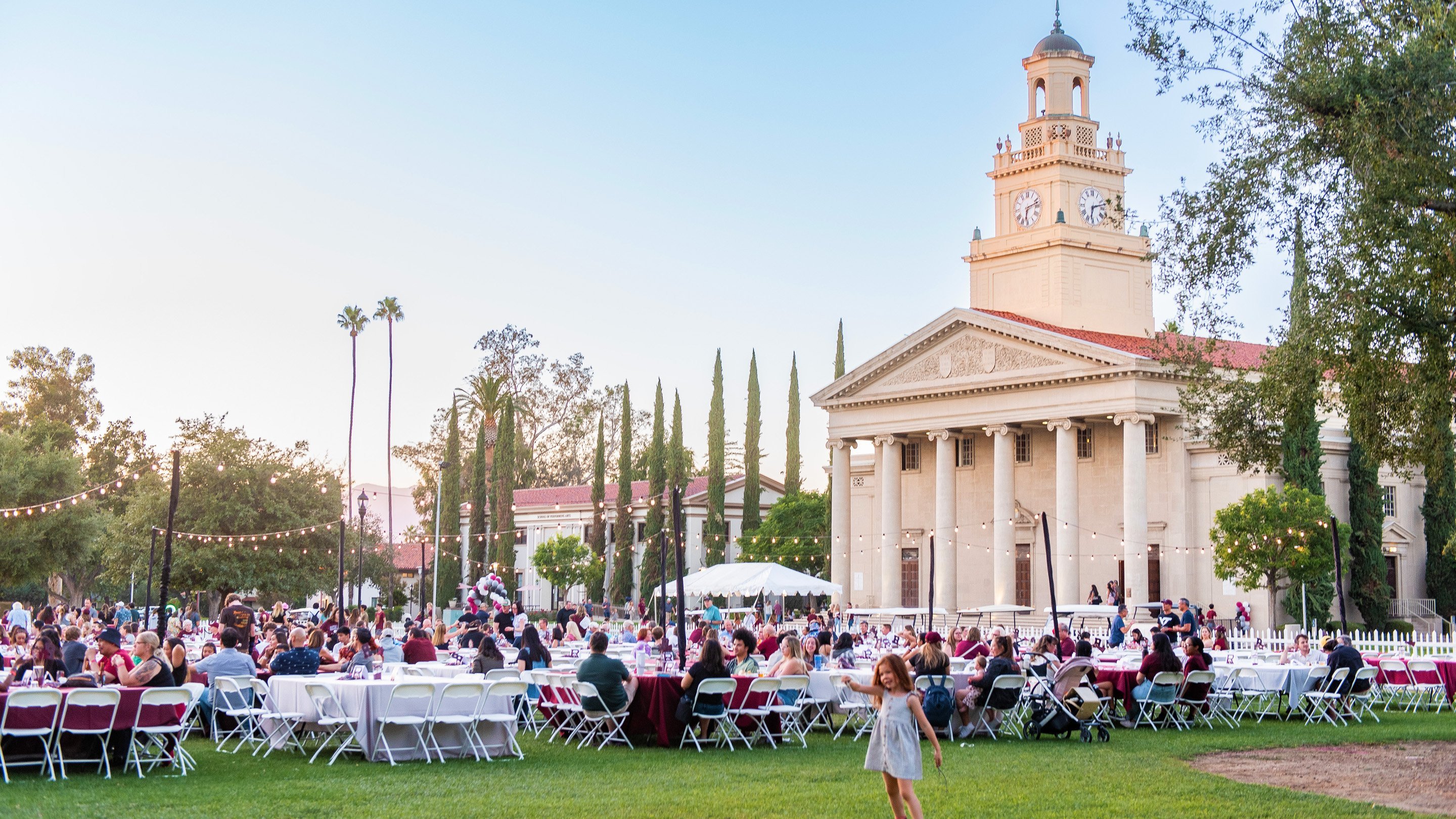 a group of people sitting in chairs outside a building