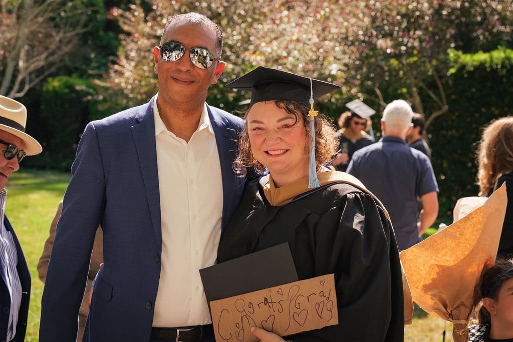 a man and woman in graduation gowns
