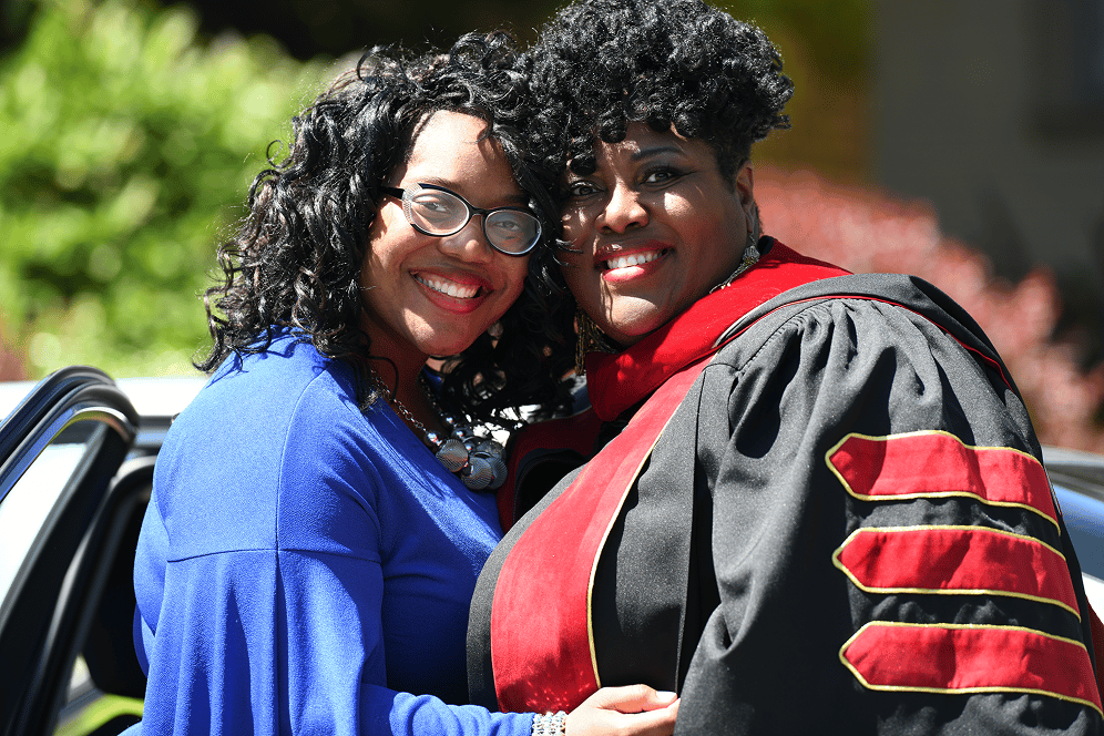 two women in graduation gowns