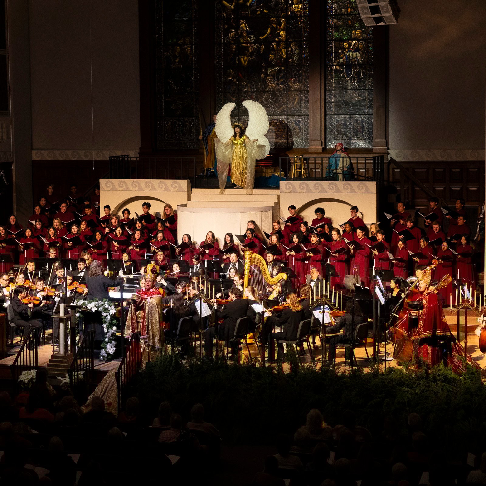 a group of people in red robes on a stage