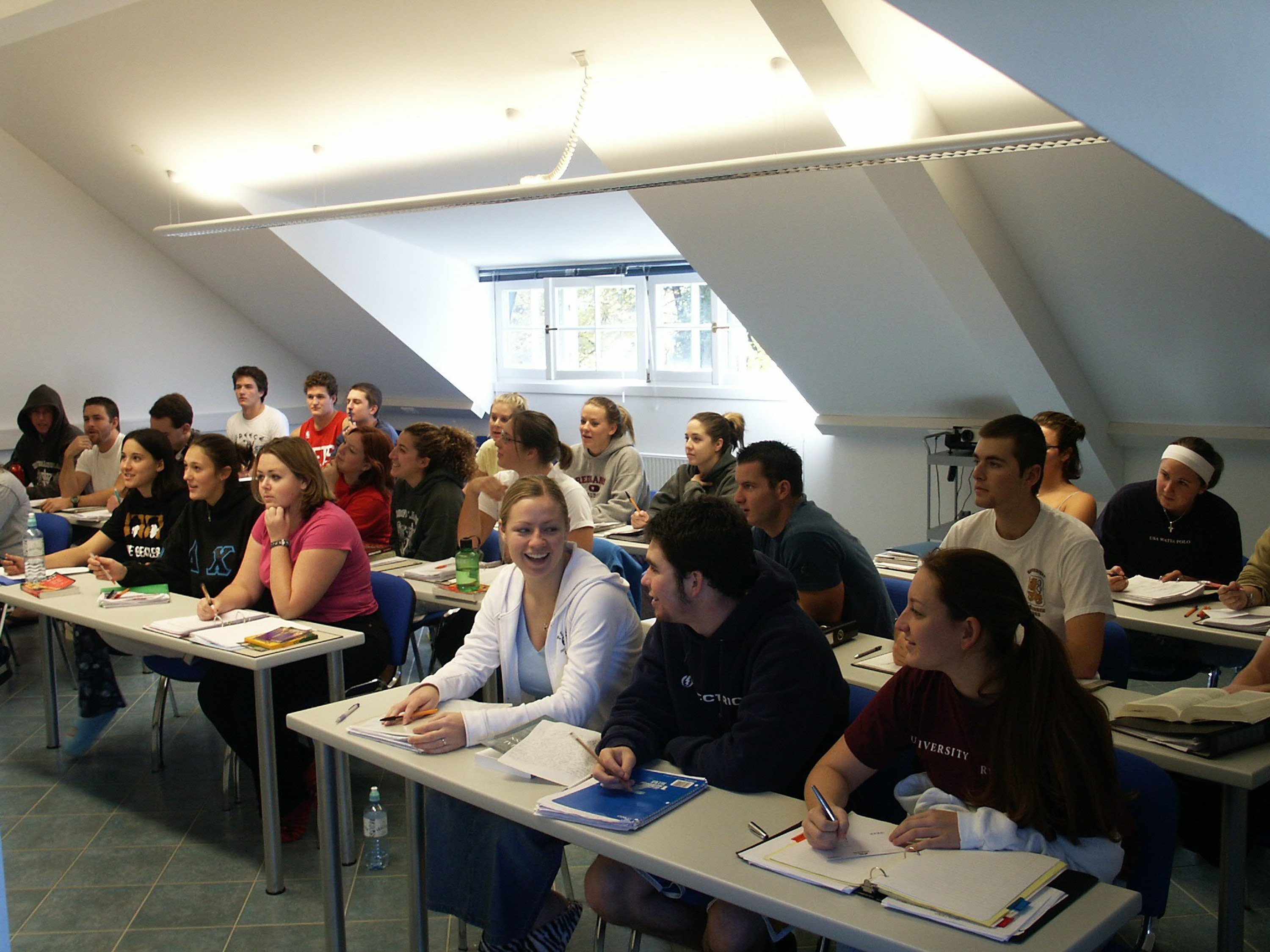 a group of people sitting in a classroom