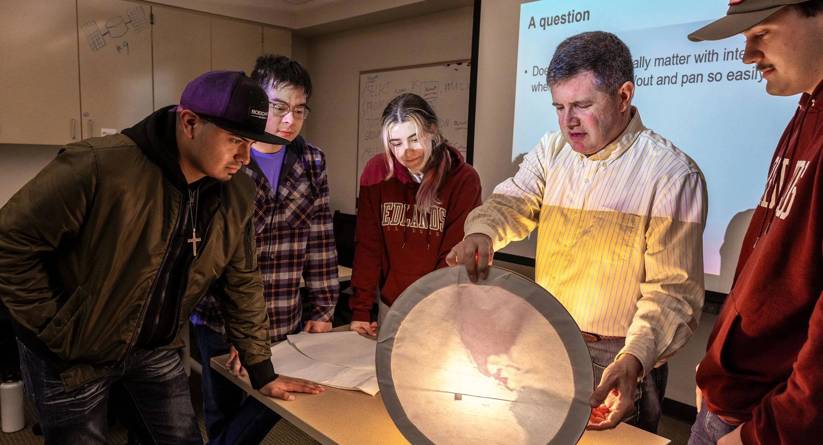 a group of people looking at a paper plate