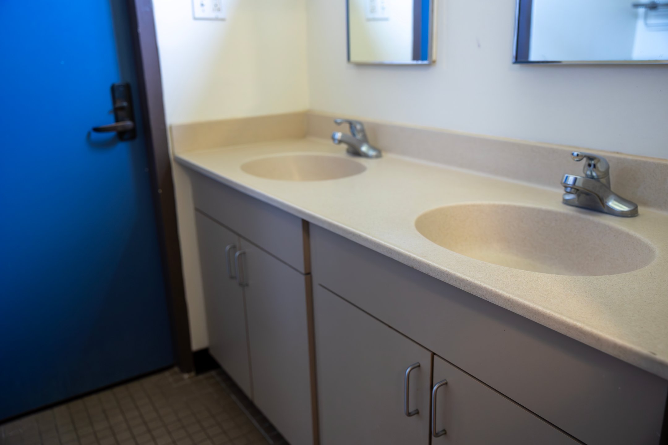 a bathroom with two sinks and mirrors