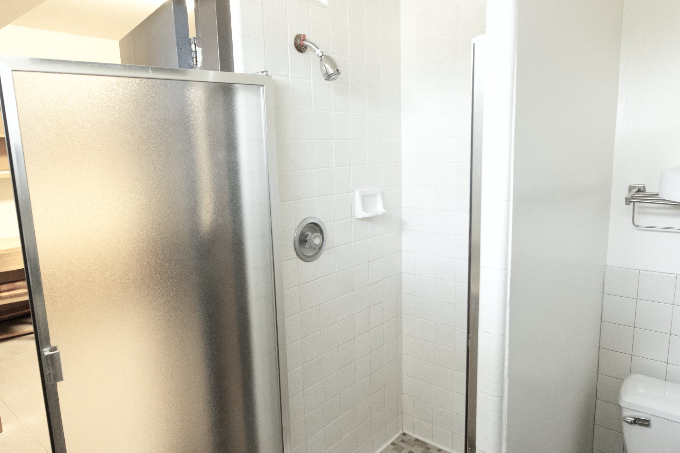 a shower with a silver shower head