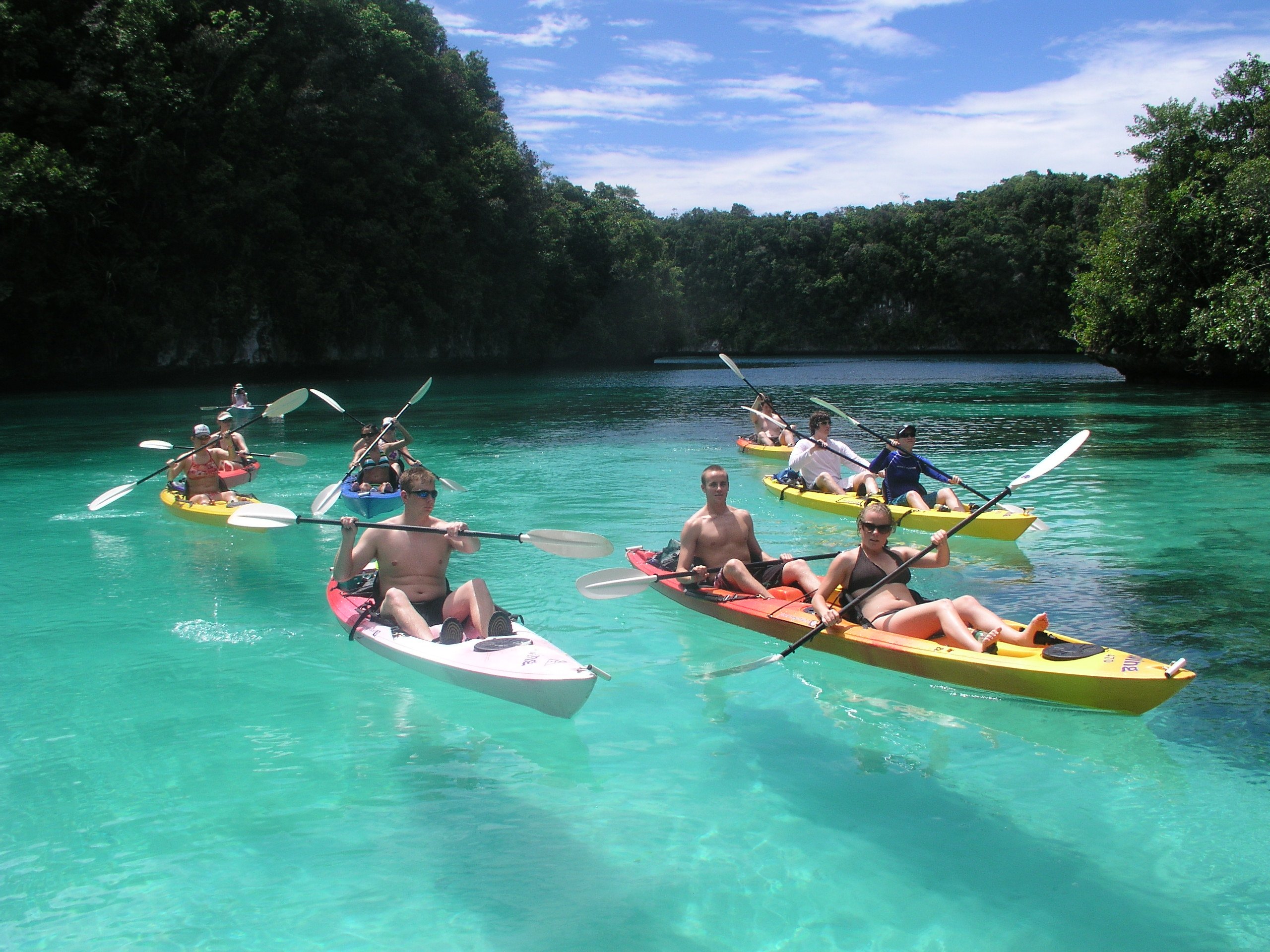 a group of people in kayaks on clear water