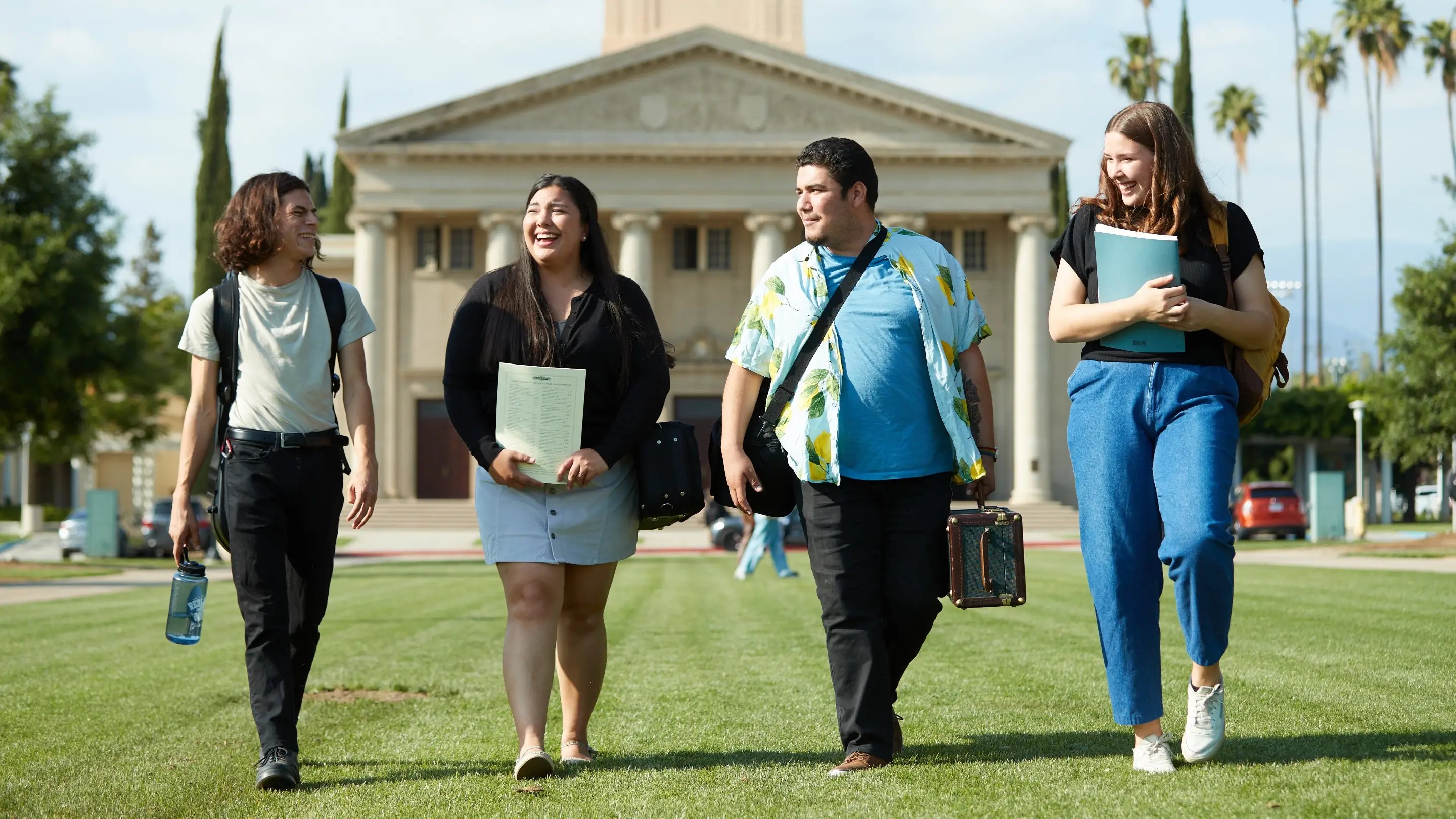 a group of people walking on a lawn