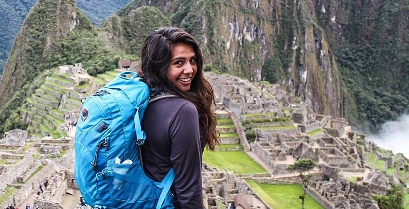 a woman with a backpack on a mountain