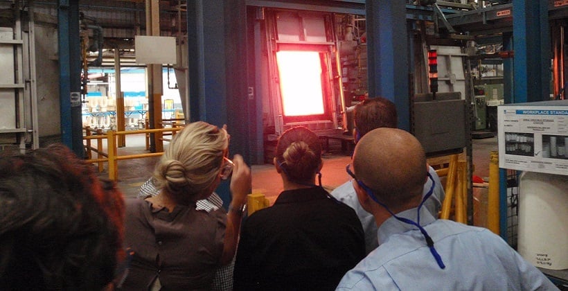 a group of people looking at a large screen