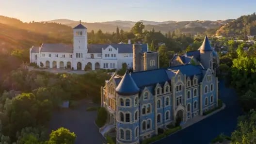 a large building with a tower and a large white building