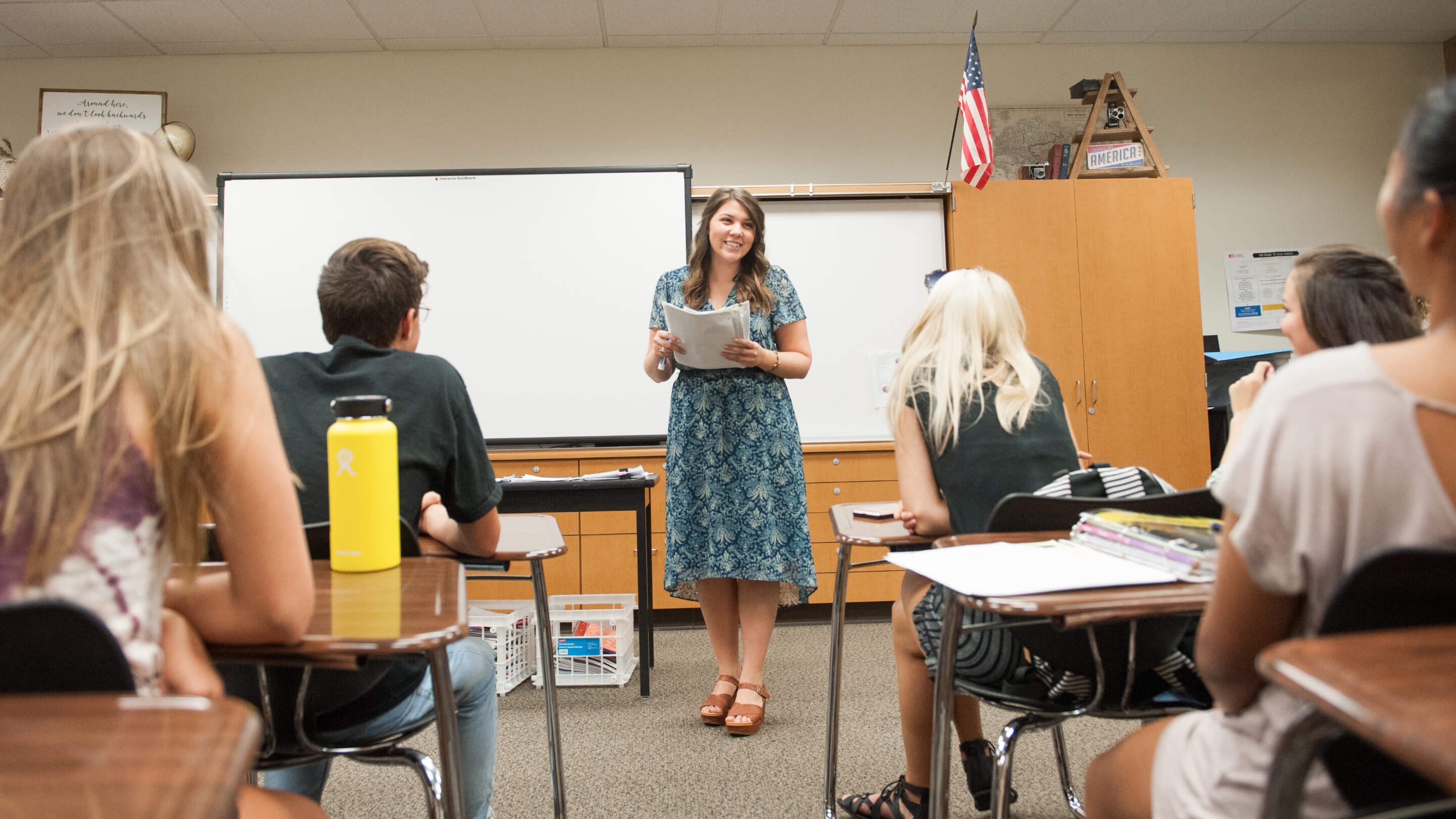 a woman standing in front of a whiteboard