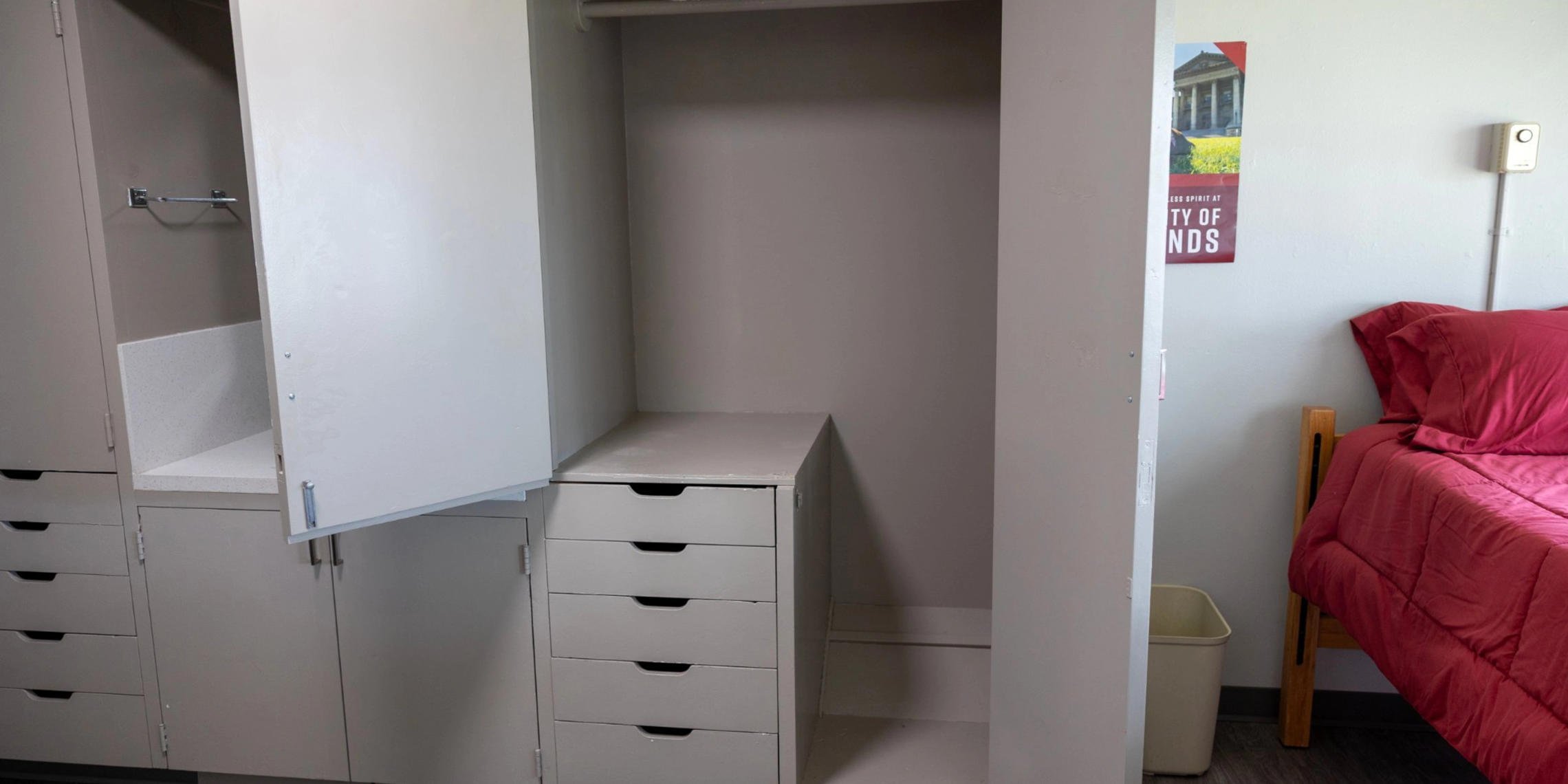 a closet with drawers and a swinger
