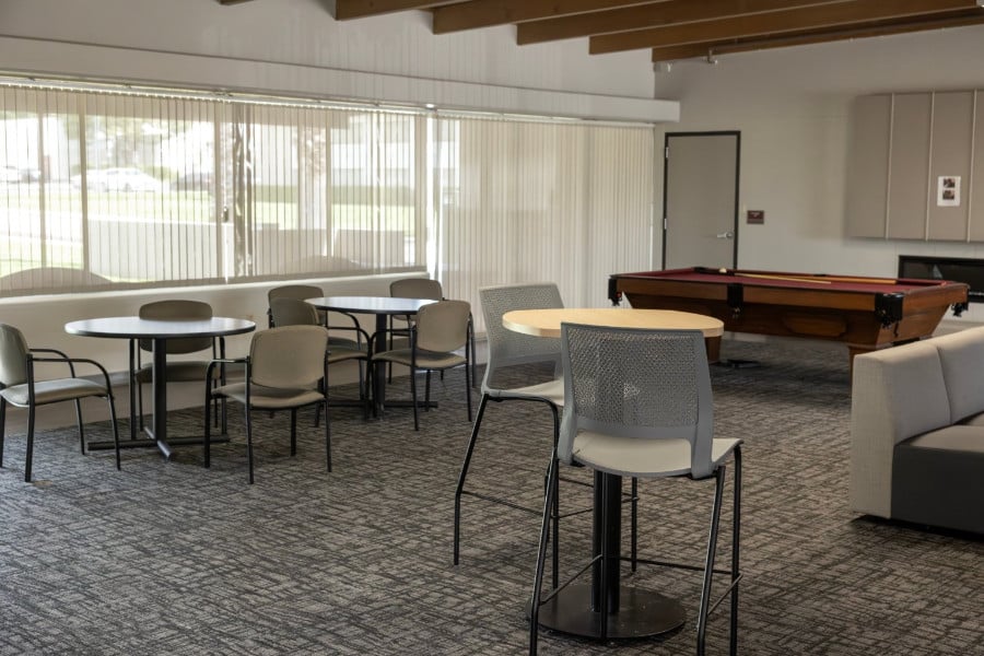 a room with tables and pool table