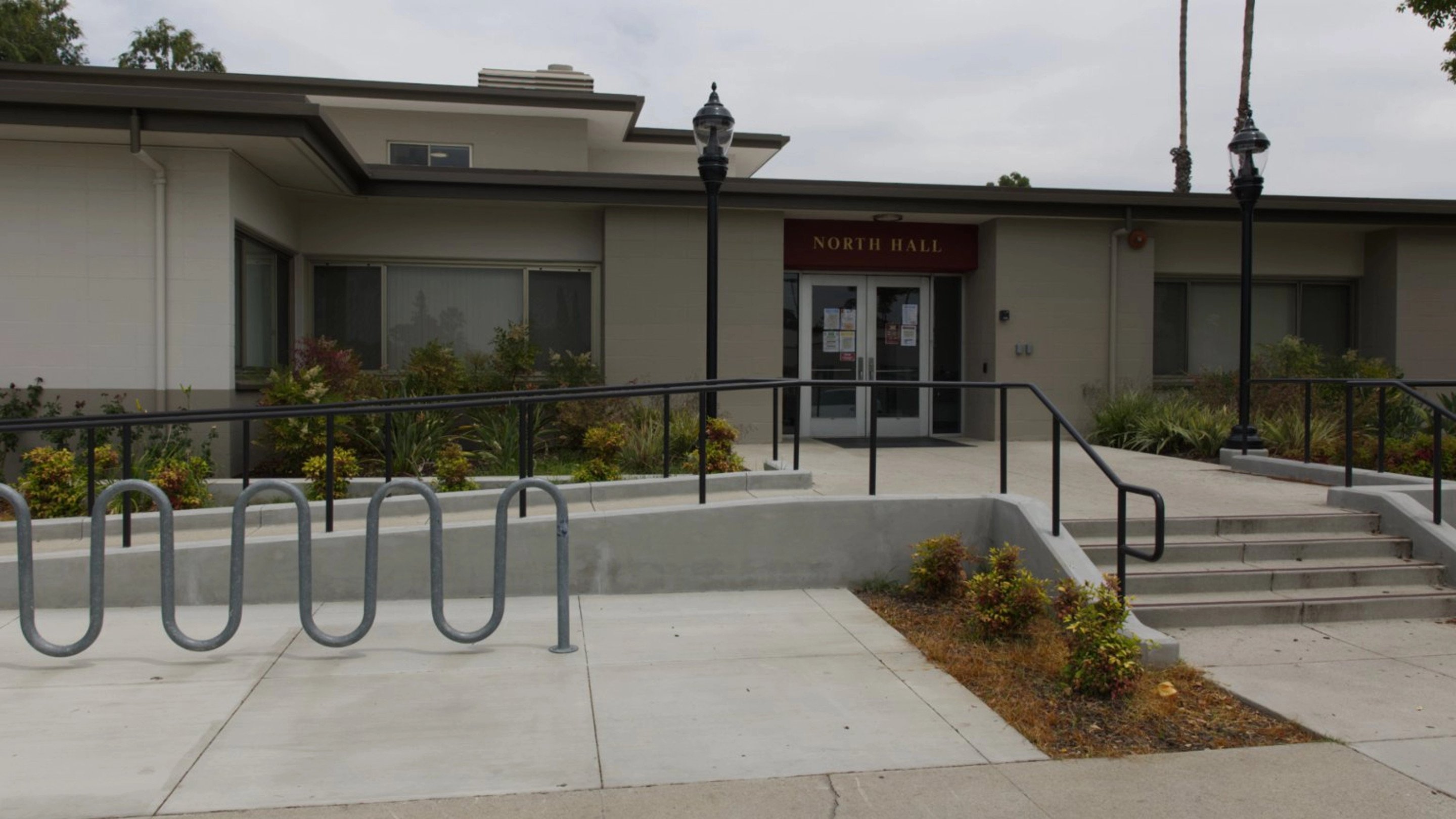 a building with a railing and a lamp post
